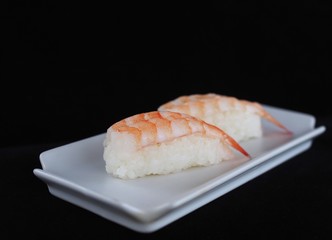 Close up delicious sushi over dark background copy space.