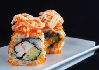 Close up delicious sushi over dark background copy space.