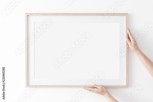 Download Landscape Large 50x70 20x28 A3 A4 Wooden Frame Mockup With Passe Partout On White Wall In Women Hands Poster Mockup Clean Modern Minimal Frame Empty Fra Me Indoor Interior Show Text Or Wall