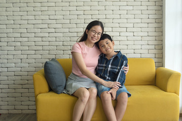  woman sitting on sofa with son