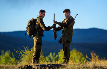 Masculine hobby activity. Men bearded hunters with rifle nature background. Experience and practice...