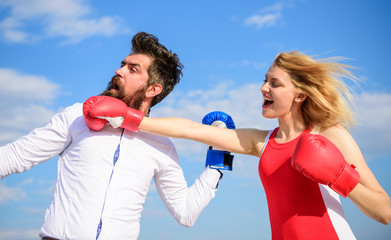 Relations as struggle concept. Man and woman fight boxing gloves blue sky background. Defend your opinion in confrontation. Relations and family life as everyday struggle. Couple in love fighting