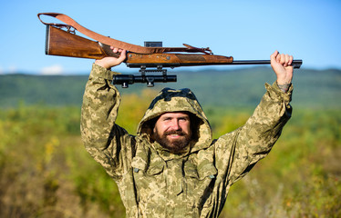 Bearded hunter rifle nature background. Harvest animals typically restricted. Hunting hobby...