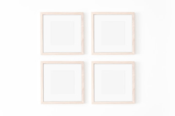 Set of four square frmes with passe-partout. Wooden frame mockup on white wall. Poster mockup....