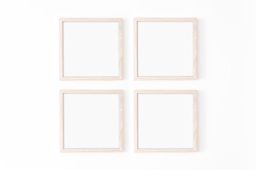 Set of four square frmes. Wooden frame mockup on white wall. Poster mockup. Clean, modern, minimal frame. Empty fra.me Indoor interior, show text or product
