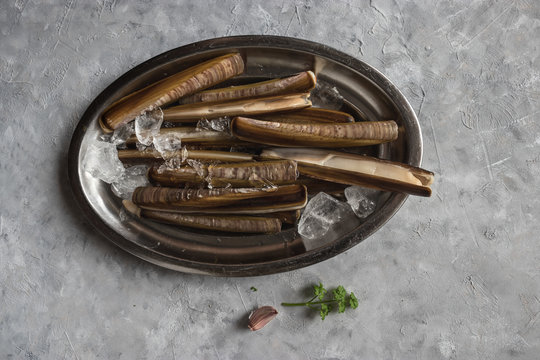 Plate with ice and razor clams