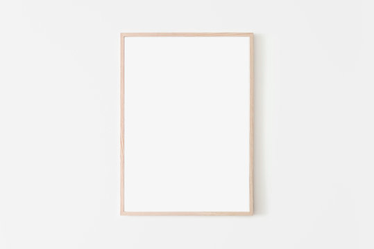 Portrait large 50x70, 20x28, a3,a4, Wooden frame mockup on white wall. Poster mockup. Clean, modern, minimal frame. Empty fra.me Indoor interior, show text or product