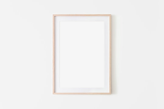 Portrait large 50x70, 20x28, a3,a4, Wooden frame mockup on white wall. Poster mockup. Clean, modern, minimal frame. Empty fra.me Indoor interior, show text or product