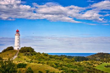 Classic view of the famous lighthouse Dornbusch on the beautiful island Hiddensee with a view of the Baltic Sea, Mecklenburg-Vorpommern, Germany - obrazy, fototapety, plakaty