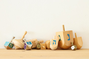 Banner of jewish holiday Hanukkah with wooden dreidels (spinning top).