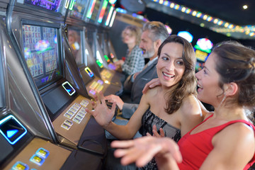 group of people playing slot and various machines