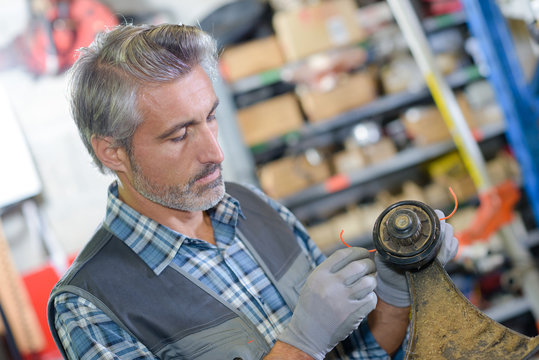 Mechanic working on strimmer head