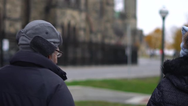 Close up of a senior man walking outdoors around parliament hill of Canada