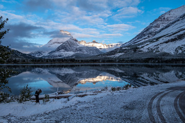 Mt Henkel reflected in Swiftcurrent Lake in the early dawn light after a snow storm. Glacier...