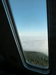 View from Jested Tower window above clouds during autumn afternoon, Czech Republic