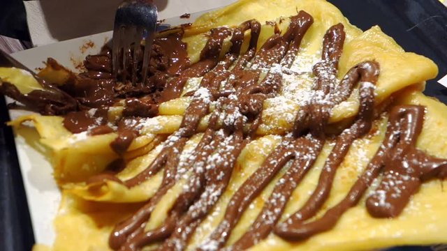 Closeup view of thin Crepes with chocolate cream.