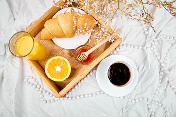 Good morning. Continental breakfast on white bed sheets.