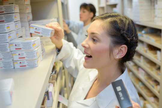 pharmacist getting medicine from stock room