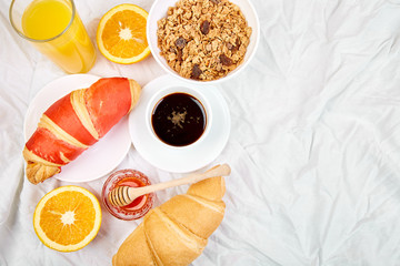 Good morning. Continental breakfast on white bed sheets.