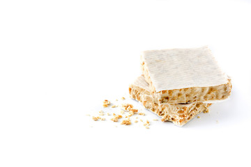 Typical christmas almond nougat isolated on white background. Copyspace