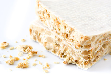 Typical christmas almond nougat isolated on white background. Close up