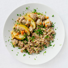 turkey stewed with apples and vegetables garnished with buckwheat decorated with parsley