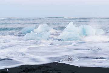 Icebergs floating and melting in arctic ocean. Pieces of ice drifted out of Jokulsarlon lagoon, Iceland