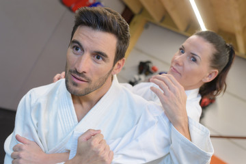 young female and male judokas training