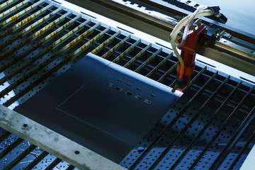 stage of production of printed circuit boards - laser cutting in automatic mode, emitter is blurred...