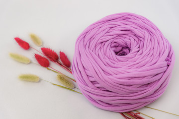 Studio photo of a skein of handmade yarn on a white background