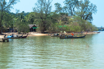 Sea Gypsies on their long-tail boats at the east side beach Ao Mae Mai on the island Ko Phayam in Thailand