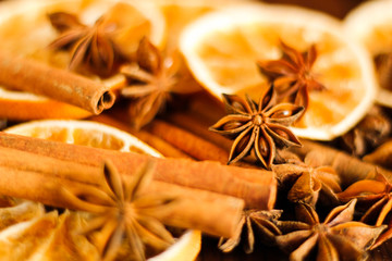 Christmas spices background: dry orange slices, anise stars, cinnamon sticks, selective focus