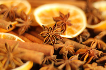 Christmas spices background: dry orange slices, anise stars, cinnamon sticks, selective focus