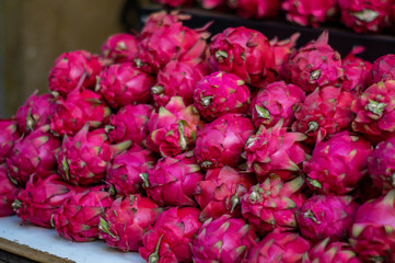 Concept of food market. Berries dragon fruit pitahaya, pineapple at the market stall. Exotic tropical fruits.