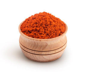 Red paprika powder in wooden bowl isolated on white background