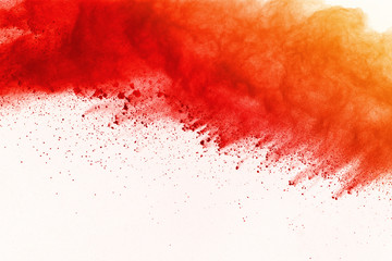 Red powder explosion on white background. Paint Holi.