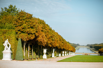 Versailles garden with beautiful sculptures, vases and trimmed bushes in Versaillle palace in France