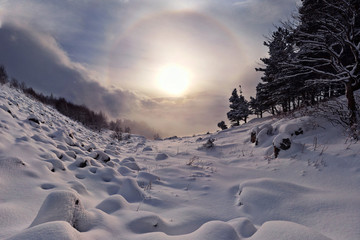 sunny halo in winter mountains