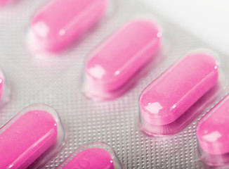 Pink tablet pills in blister