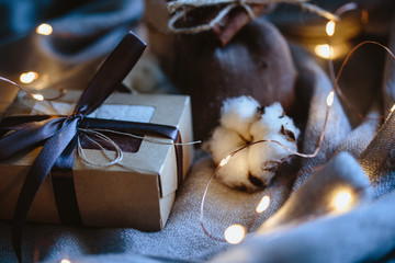 Cozy winter composition with eco gifts and christmas lights, flat lay, mock up, macro photo