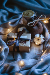 Cozy winter composition with eco gifts and christmas lights, flat lay, mock up, macro photo
