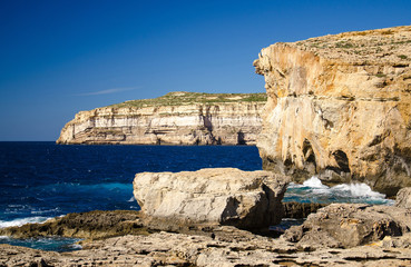 Rocky coastline cliffs near collapsed Azure window, Gozo island, Malta