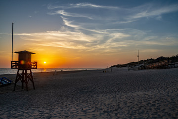 The sun setting behind a lifeguard tower in Rota, Spain.