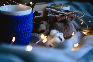 Cozy winter composition with eco gifts and christmas lights, flat lay, mock up, macro photo