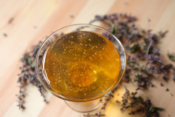 Light floral honey pours into a glass bowl