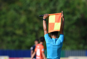 Assistant referee hold flag , substitution signal.