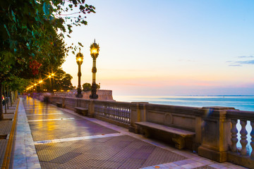 A colorful evening scene in a park in Cadiz, Spain with settle motion blurs of people and starburst in every street light. © Jason Yoder