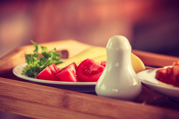 Tomatoes, lettuce and cheese served on plate