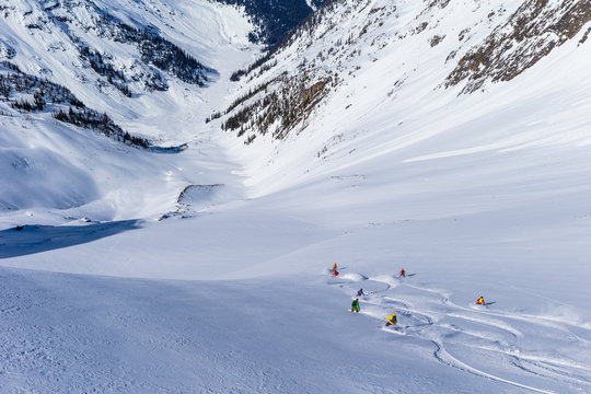 Skiers skiing down a snowy mountain