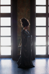 Sensual young woman in a geisha asian costume with fashion makeup and hair style